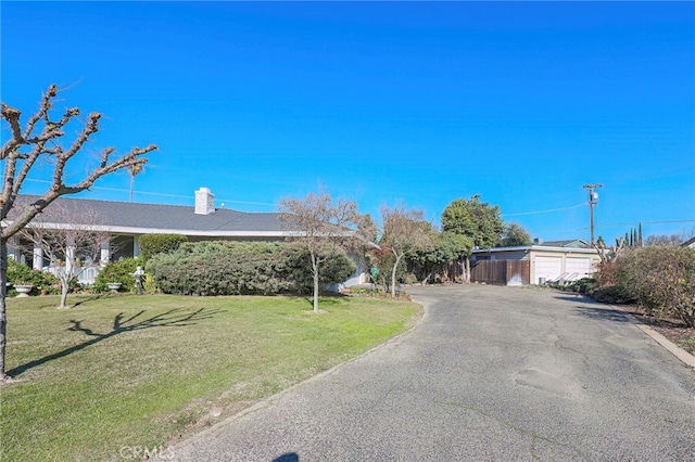 ranch-style home featuring a garage and a front yard