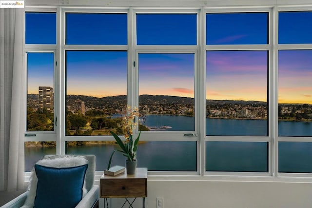 unfurnished sunroom featuring a water view