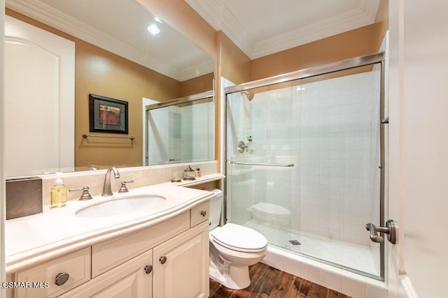 bathroom featuring crown molding, vanity, toilet, and a shower with shower door