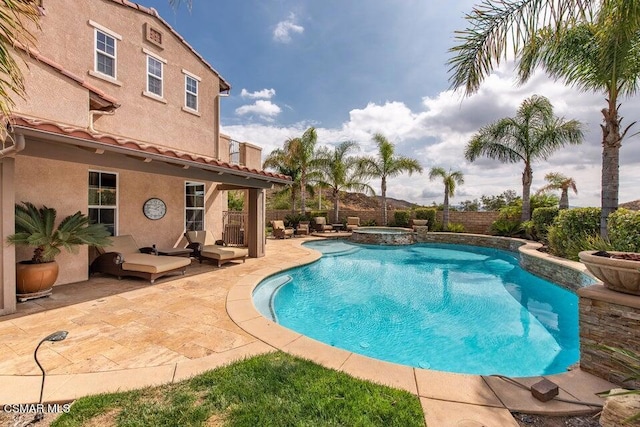 view of swimming pool with an in ground hot tub and a patio area