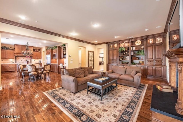 living room featuring hardwood / wood-style flooring, crown molding, and an inviting chandelier