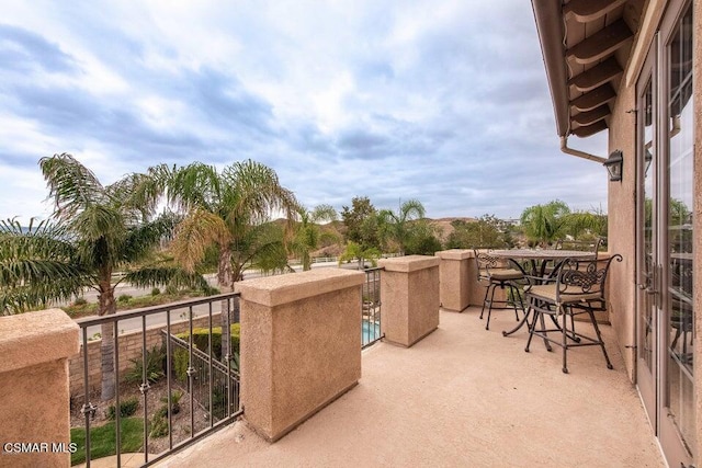 view of patio featuring a balcony