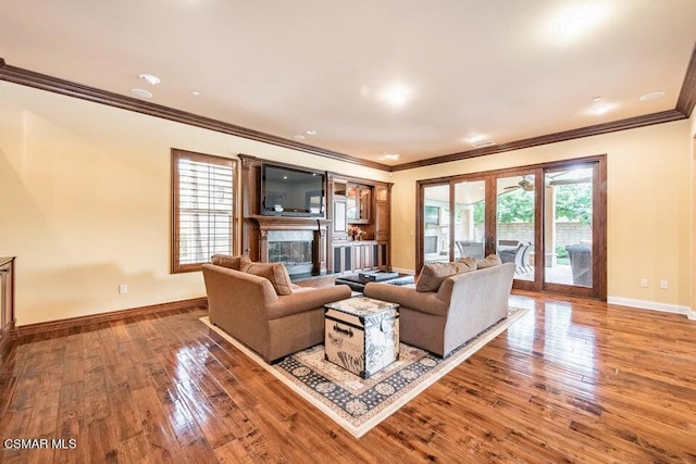 living room with hardwood / wood-style flooring and ornamental molding