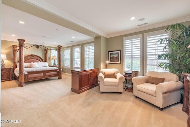 bedroom featuring light carpet, crown molding, and ornate columns