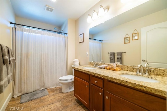 bathroom featuring hardwood / wood-style flooring, vanity, and toilet