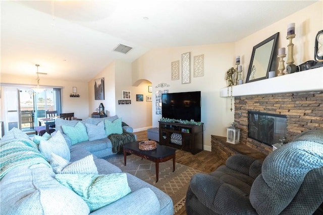 living room with lofted ceiling, dark wood-type flooring, and a fireplace