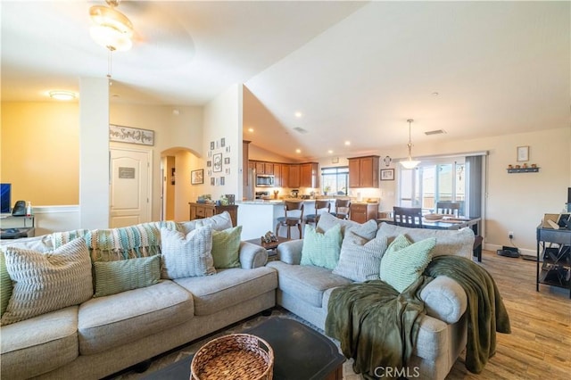 living room featuring light hardwood / wood-style flooring and vaulted ceiling