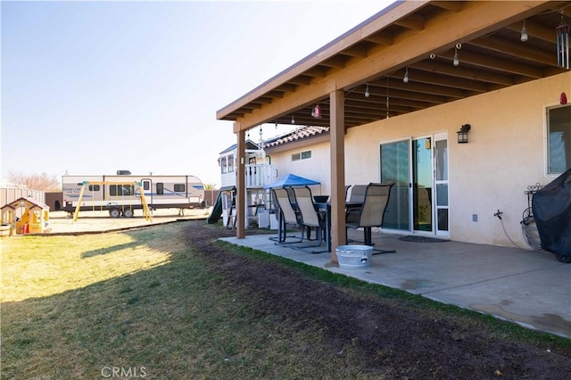 view of yard featuring a playground and a patio area