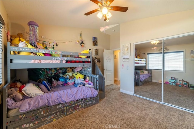 bedroom featuring lofted ceiling, a closet, ceiling fan, and carpet