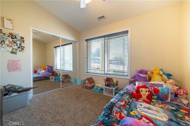 carpeted bedroom featuring ceiling fan, vaulted ceiling, and a closet