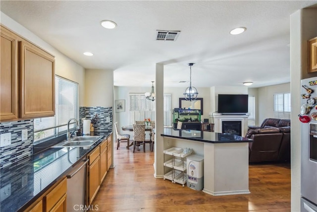 kitchen with tasteful backsplash, appliances with stainless steel finishes, sink, and dark hardwood / wood-style floors