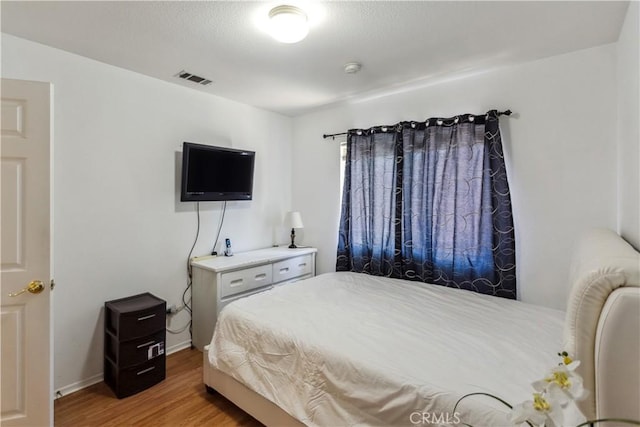 bedroom featuring hardwood / wood-style floors