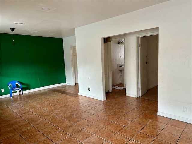 tiled spare room featuring sink