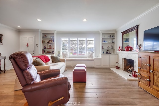 living room featuring a brick fireplace, crown molding, and light hardwood / wood-style floors