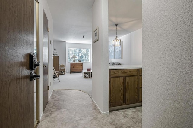 hall with light tile patterned floors