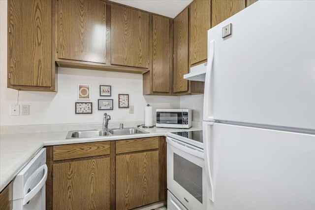 kitchen featuring white appliances and sink