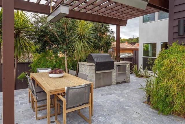 view of patio with an outdoor kitchen, a grill, and a pergola