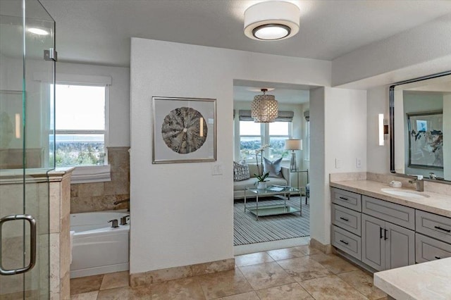 bathroom with tile patterned flooring, vanity, and shower with separate bathtub