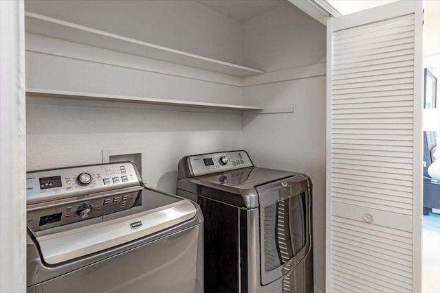 clothes washing area featuring independent washer and dryer