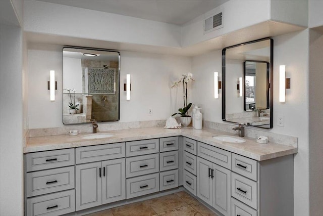 bathroom featuring vanity and a shower with shower door