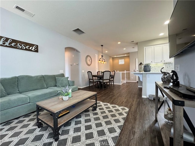 living room with dark hardwood / wood-style flooring