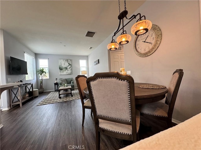 dining area with dark hardwood / wood-style flooring