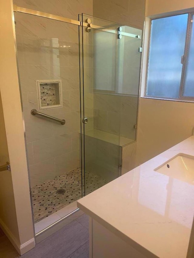 bathroom featuring vanity and a shower with shower door