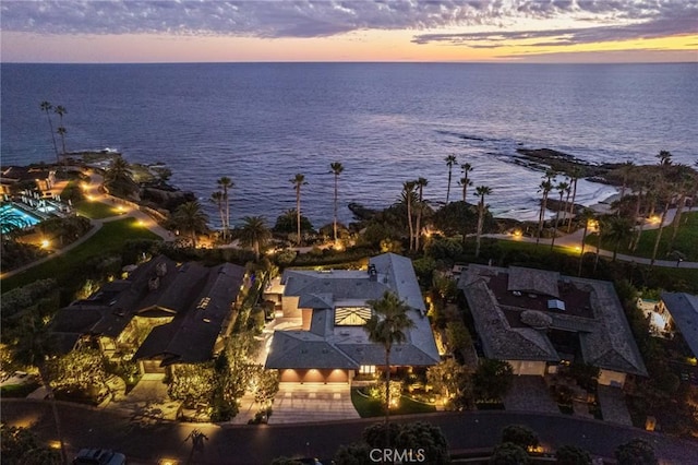 aerial view at dusk with a water view