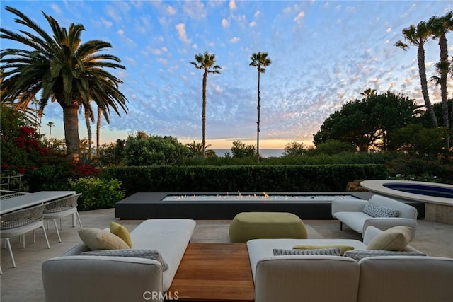 patio terrace at dusk with an in ground hot tub