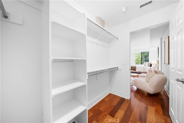 walk in closet featuring dark hardwood / wood-style flooring