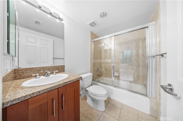 full bathroom with tile patterned flooring, vanity, toilet, and combined bath / shower with glass door