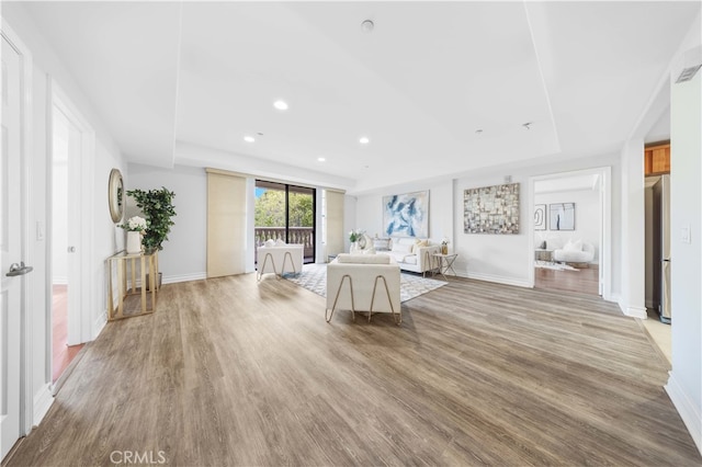 interior space featuring access to outside, stainless steel refrigerator, and light hardwood / wood-style flooring