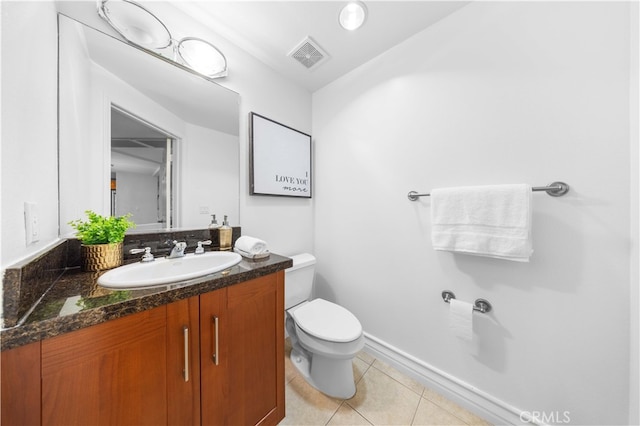 bathroom with vanity, toilet, and tile patterned flooring