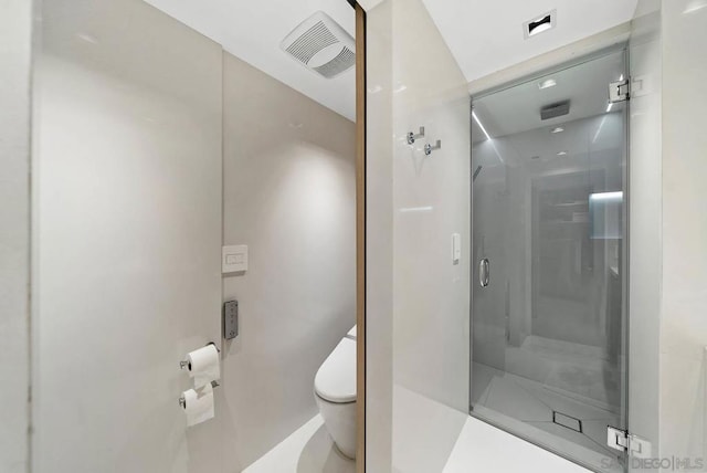 bathroom with an enclosed shower and toilet