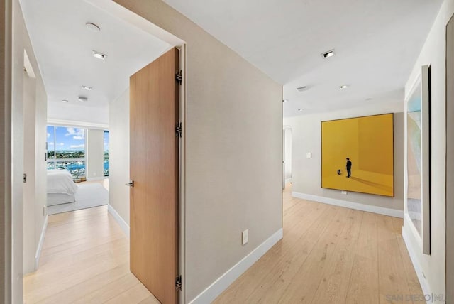 hall with light hardwood / wood-style floors