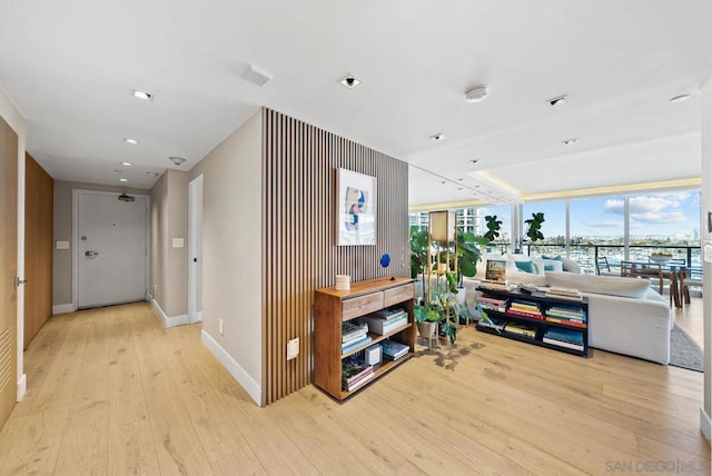 hallway with light hardwood / wood-style flooring and expansive windows