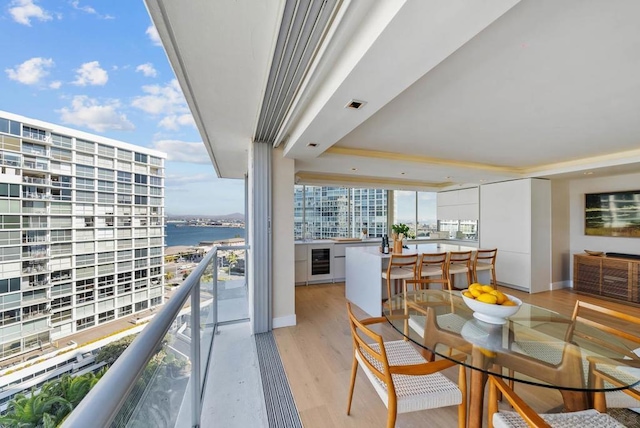 balcony with a water view and wine cooler