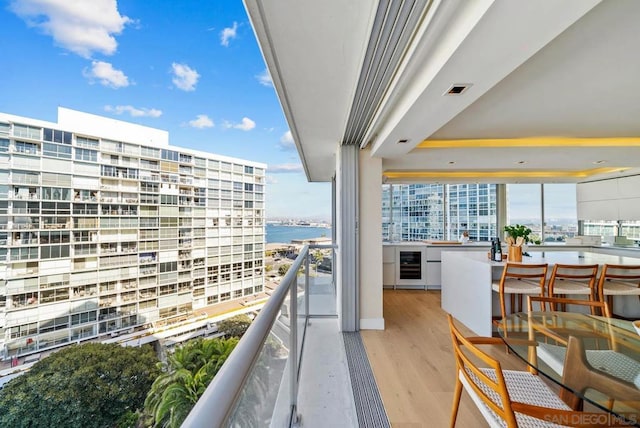 balcony with a water view and wine cooler