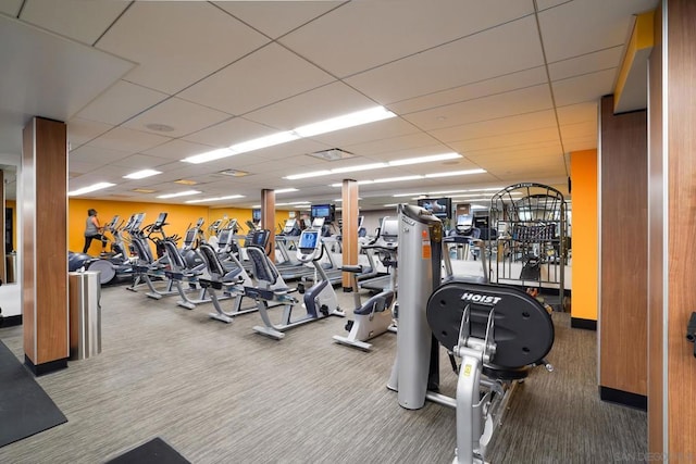 workout area with a drop ceiling and carpet flooring