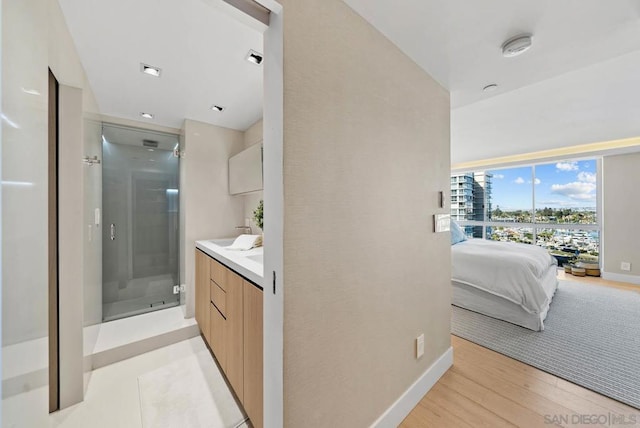 bathroom with an enclosed shower, vanity, and hardwood / wood-style flooring