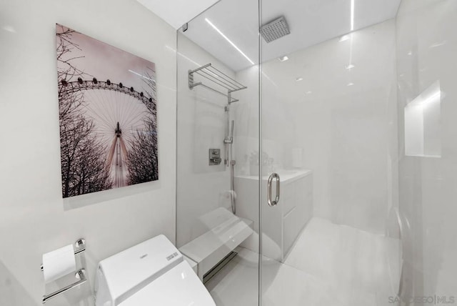 bathroom featuring washer / dryer and an enclosed shower