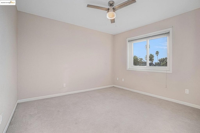 carpeted empty room featuring ceiling fan