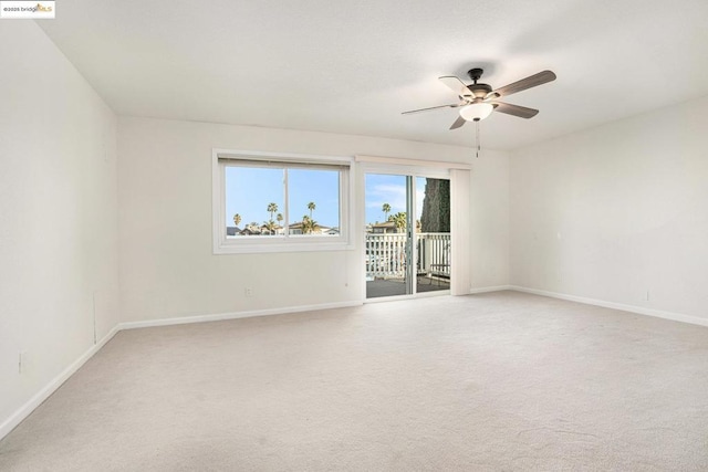 empty room featuring ceiling fan and carpet