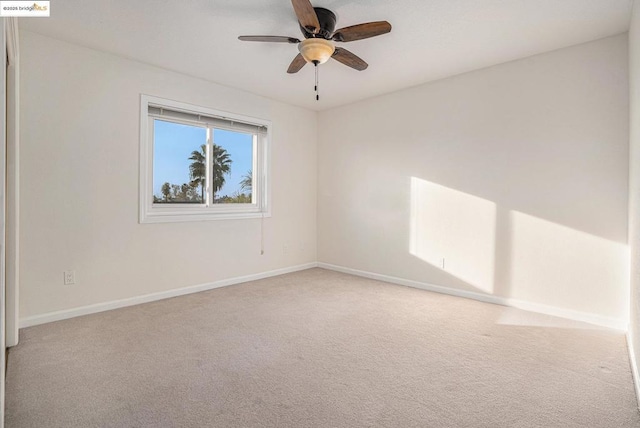 spare room with light colored carpet and ceiling fan