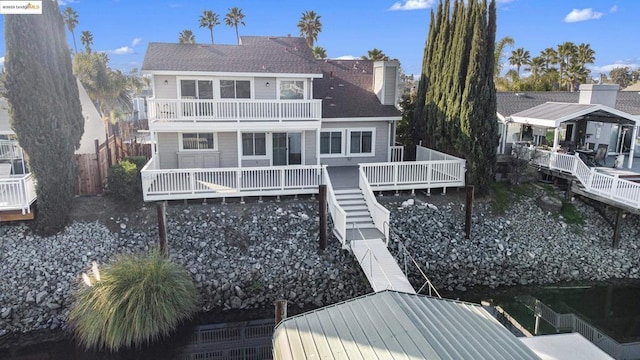 back of house featuring a balcony