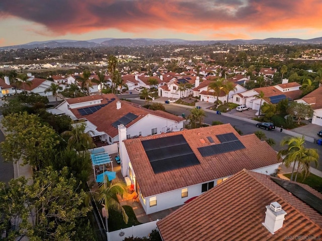 aerial view at dusk featuring a mountain view