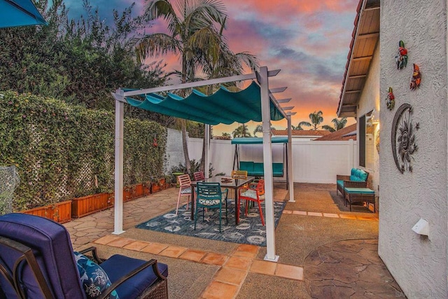 view of patio terrace at dusk