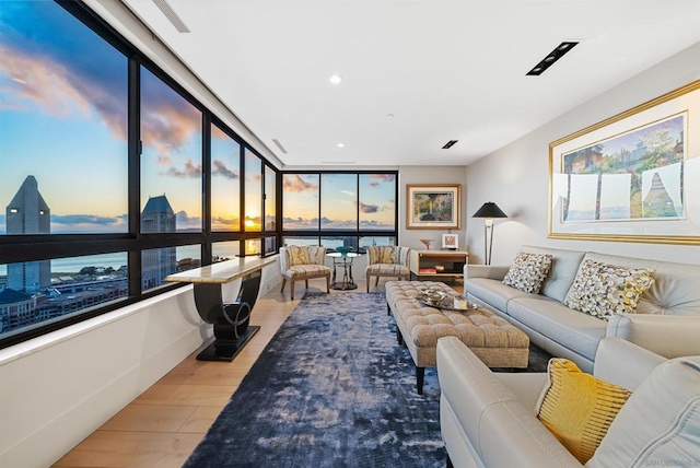 living room with a water view, plenty of natural light, and hardwood / wood-style floors