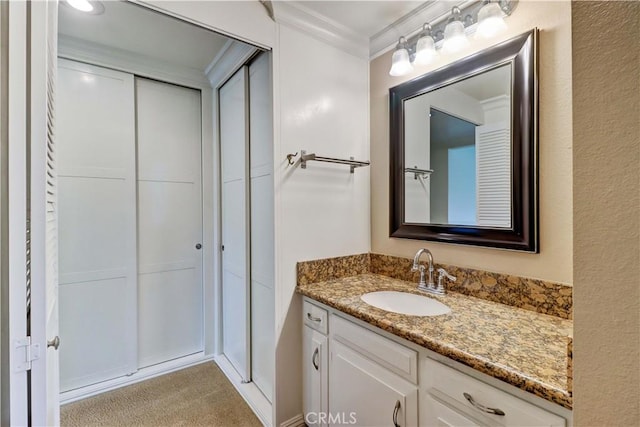 bathroom featuring ornamental molding and vanity