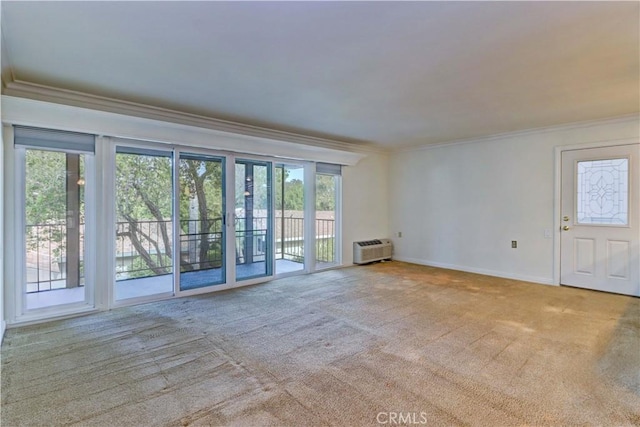 unfurnished living room featuring crown molding, light carpet, and an AC wall unit